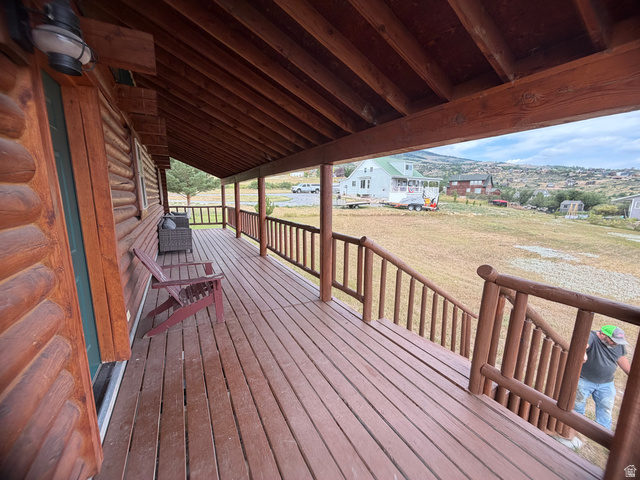 358 Maple Drive Fish Haven, ID 83287 - Photo 4 of 21 Expansive covered porch featuring a log cabin exterior, wood-finish decking, and rustic wood railings