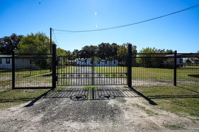 a view of a backyard with fence