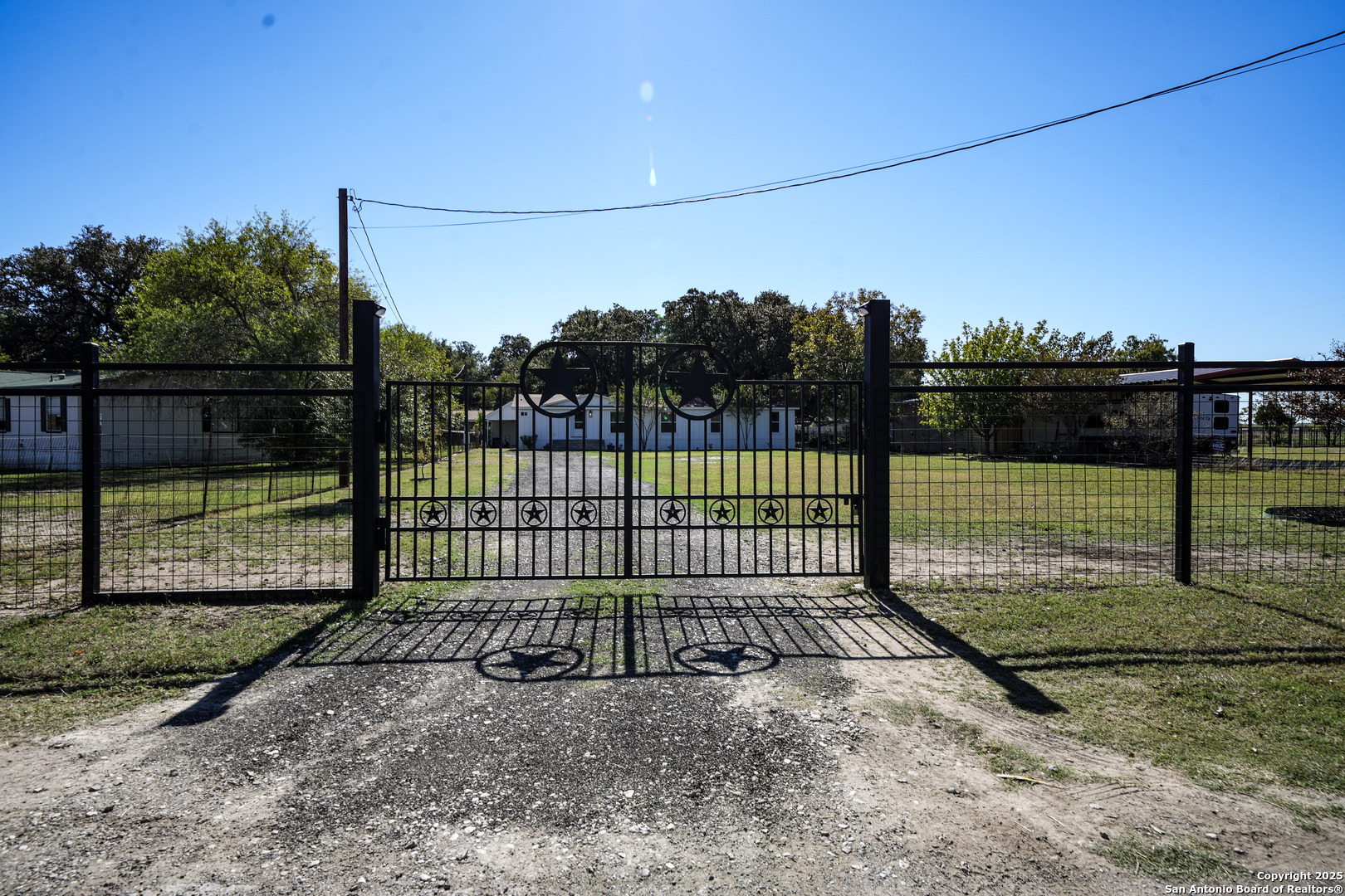 a view of a backyard with fence
