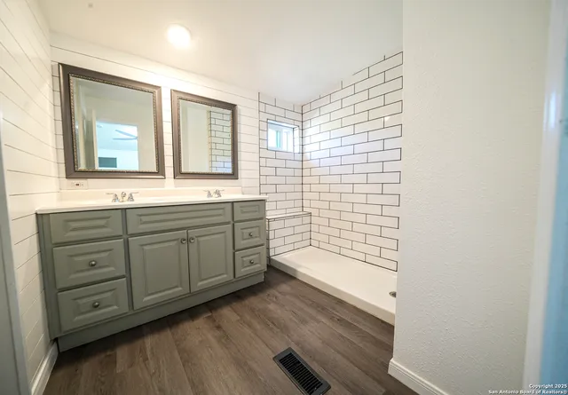 a bathroom with a sink a mirror and a bathtub