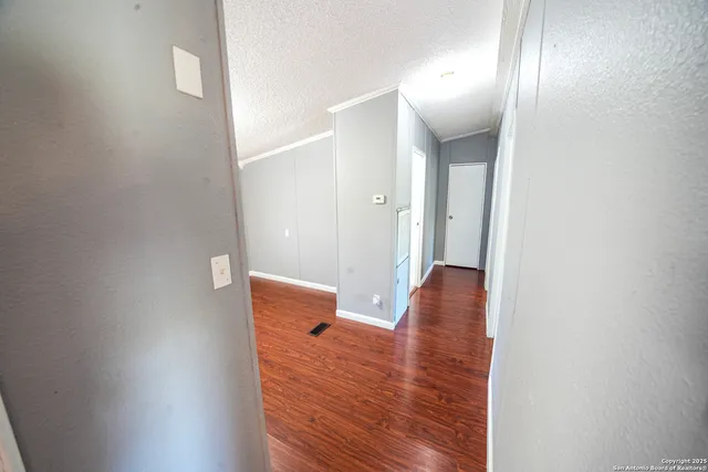 a view of room with wooden floor