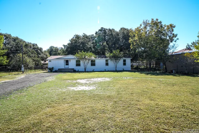 a swimming pool with outdoor seating and yard