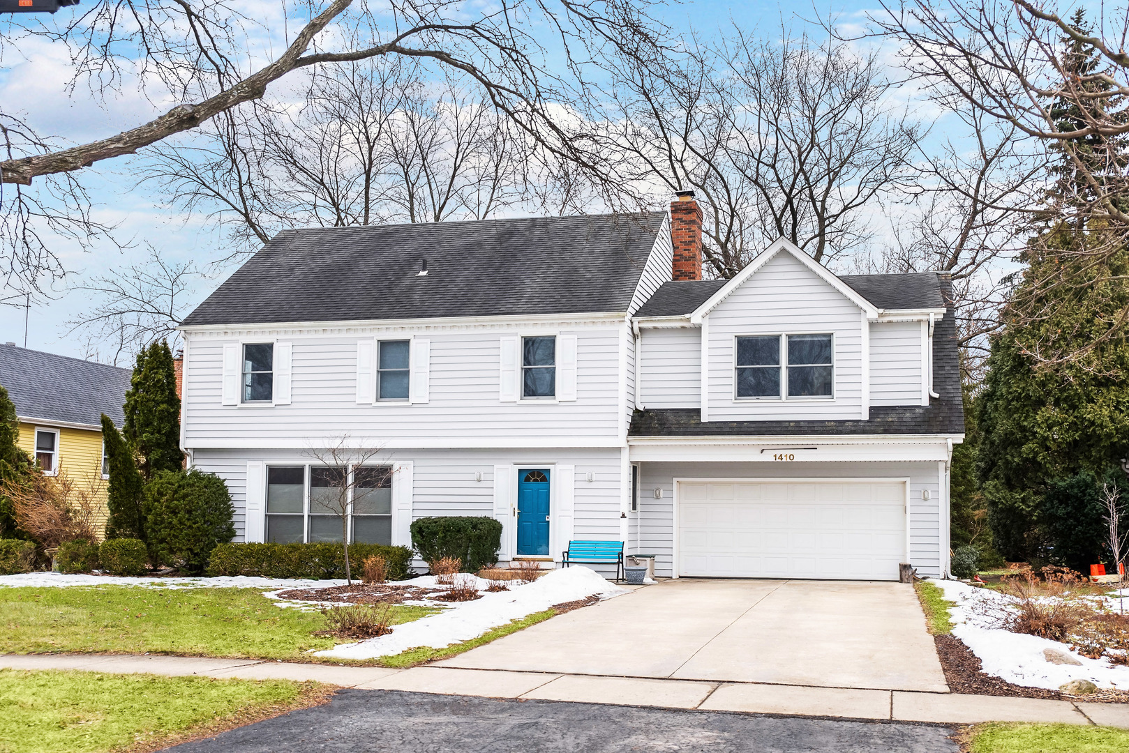 1410 Daly Road Wheaton, IL 60187 - Photo 1 of 34 a front view of a house with a yard and garage