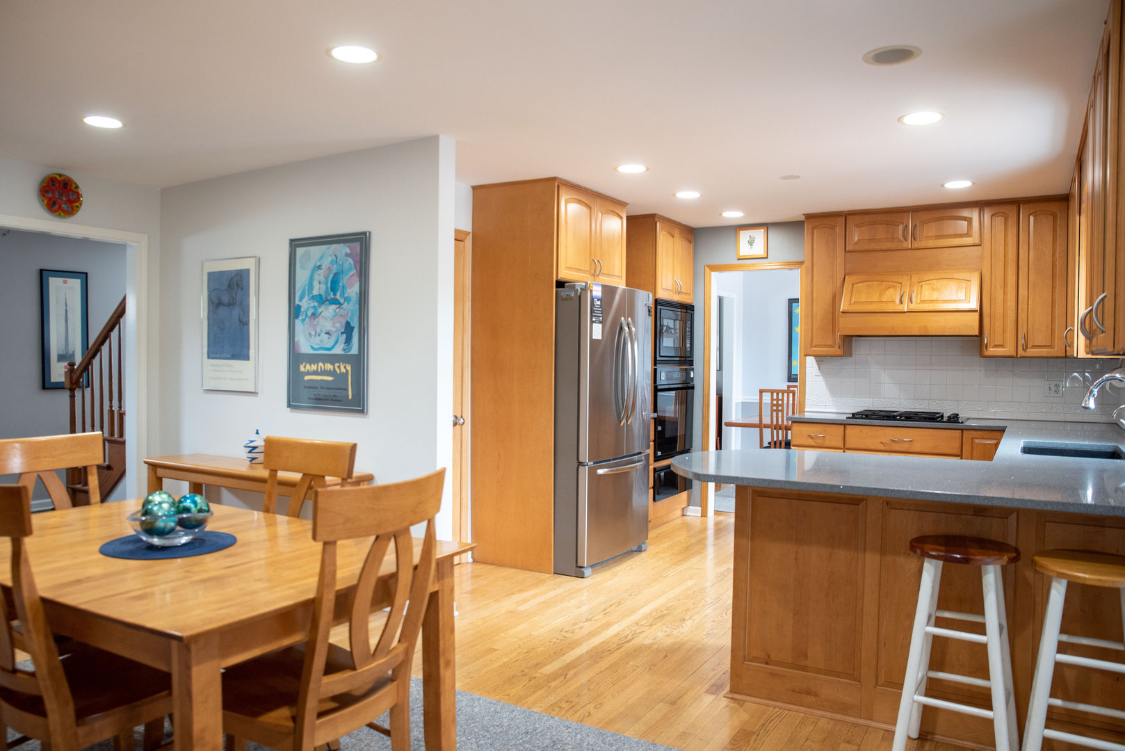 1410 Daly Road Wheaton, IL 60187 - Photo 11 of 34 a kitchen with stainless steel appliances granite countertop a table chairs and a refrigerator