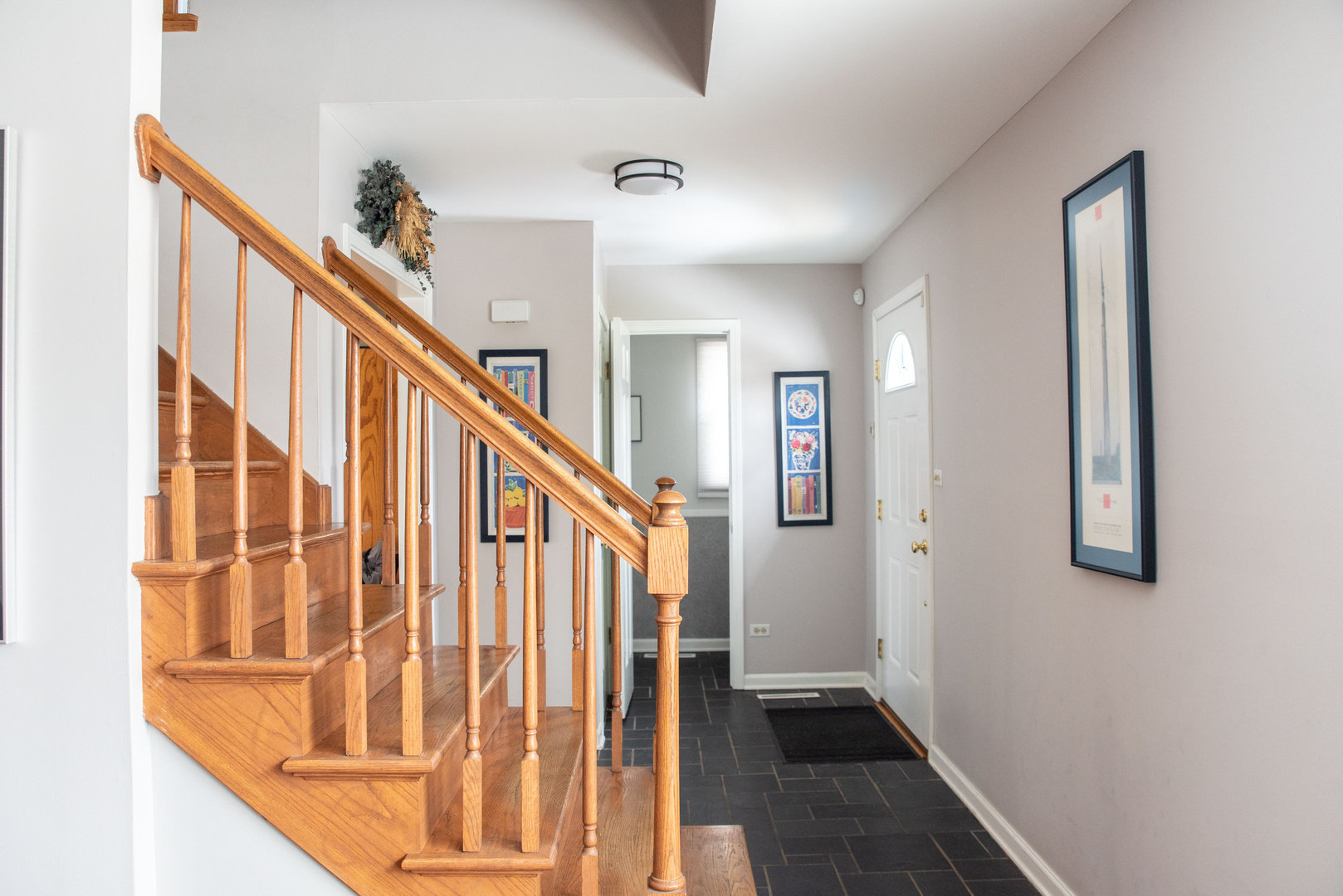 1410 Daly Road Wheaton, IL 60187 - Photo 4 of 34 a view of staircase with lots of frames on wall and a window
