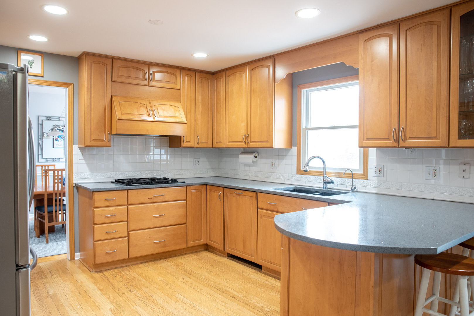 1410 Daly Road Wheaton, IL 60187 - Photo 5 of 34 a kitchen with stainless steel appliances granite countertop a sink a stove and a refrigerator