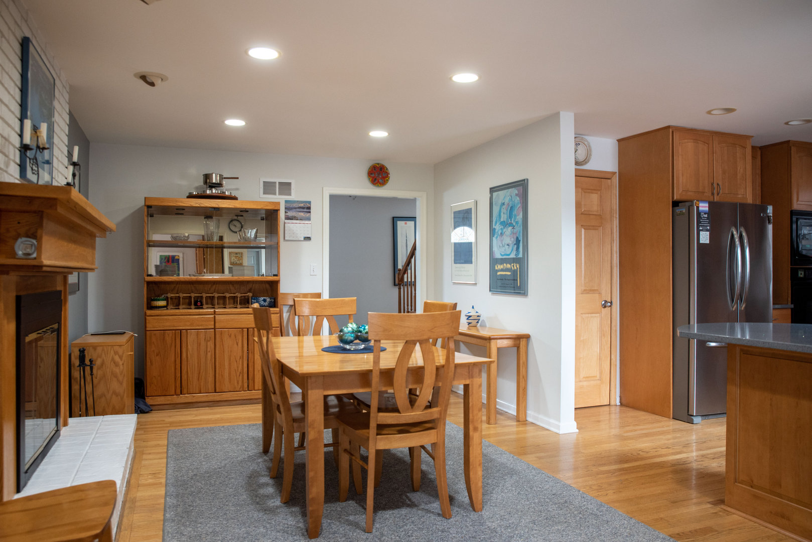 1410 Daly Road Wheaton, IL 60187 - Photo 10 of 34 a dining room with stainless steel appliances kitchen island granite countertop a refrigerator and wooden cabinets
