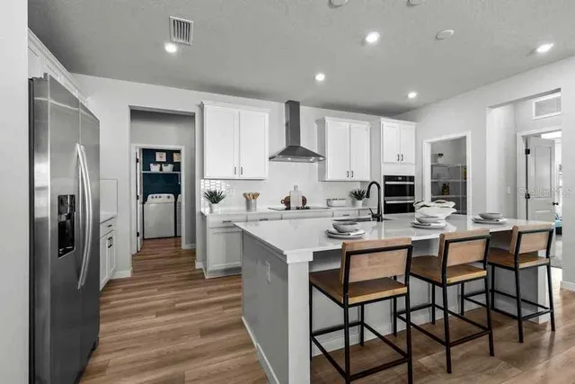 a kitchen with kitchen island granite countertop lots of counter top space and sink