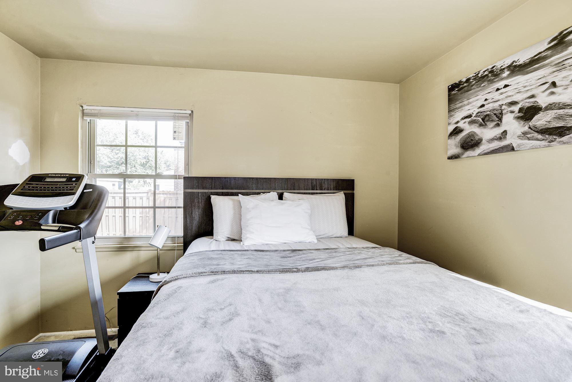 6708 Cimarron Street Springfield, VA 22150 - Photo 33 of 46 a bedroom with a bed and wooden floor