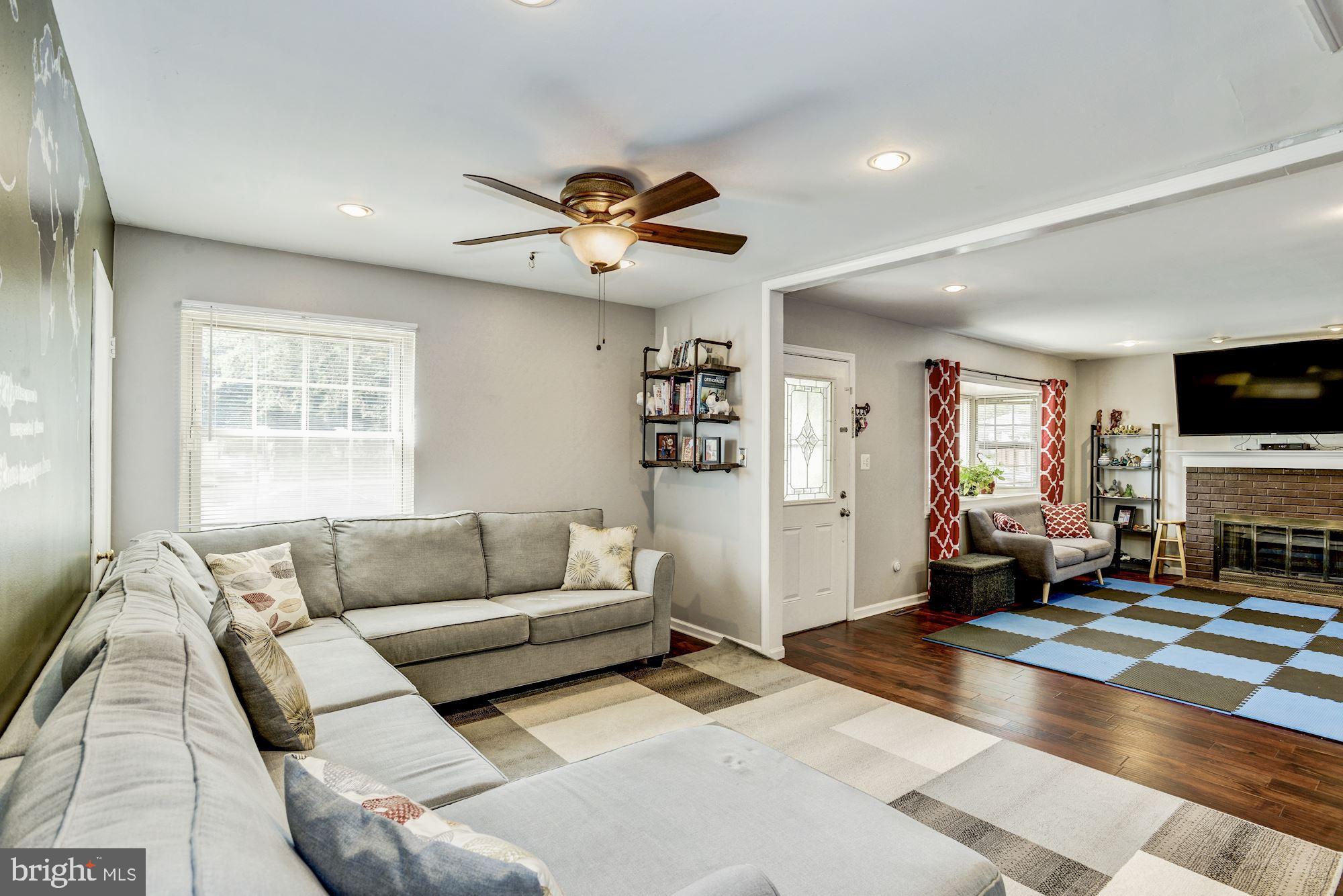 6708 Cimarron Street Springfield, VA 22150 - Photo 5 of 46 a living room with furniture and a flat screen tv