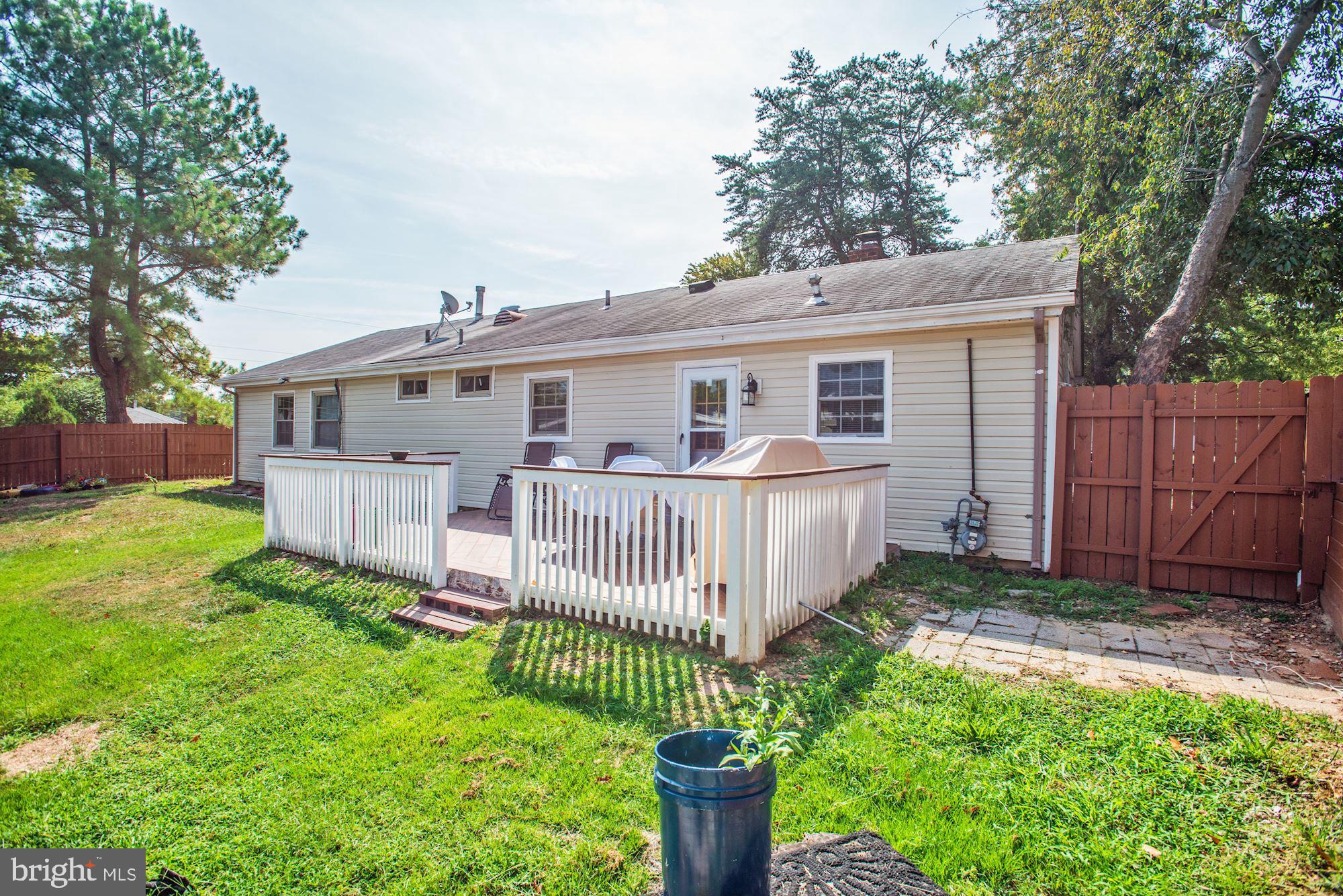 6708 Cimarron Street Springfield, VA 22150 - Photo 41 of 46 a view of a house with a yard and deck