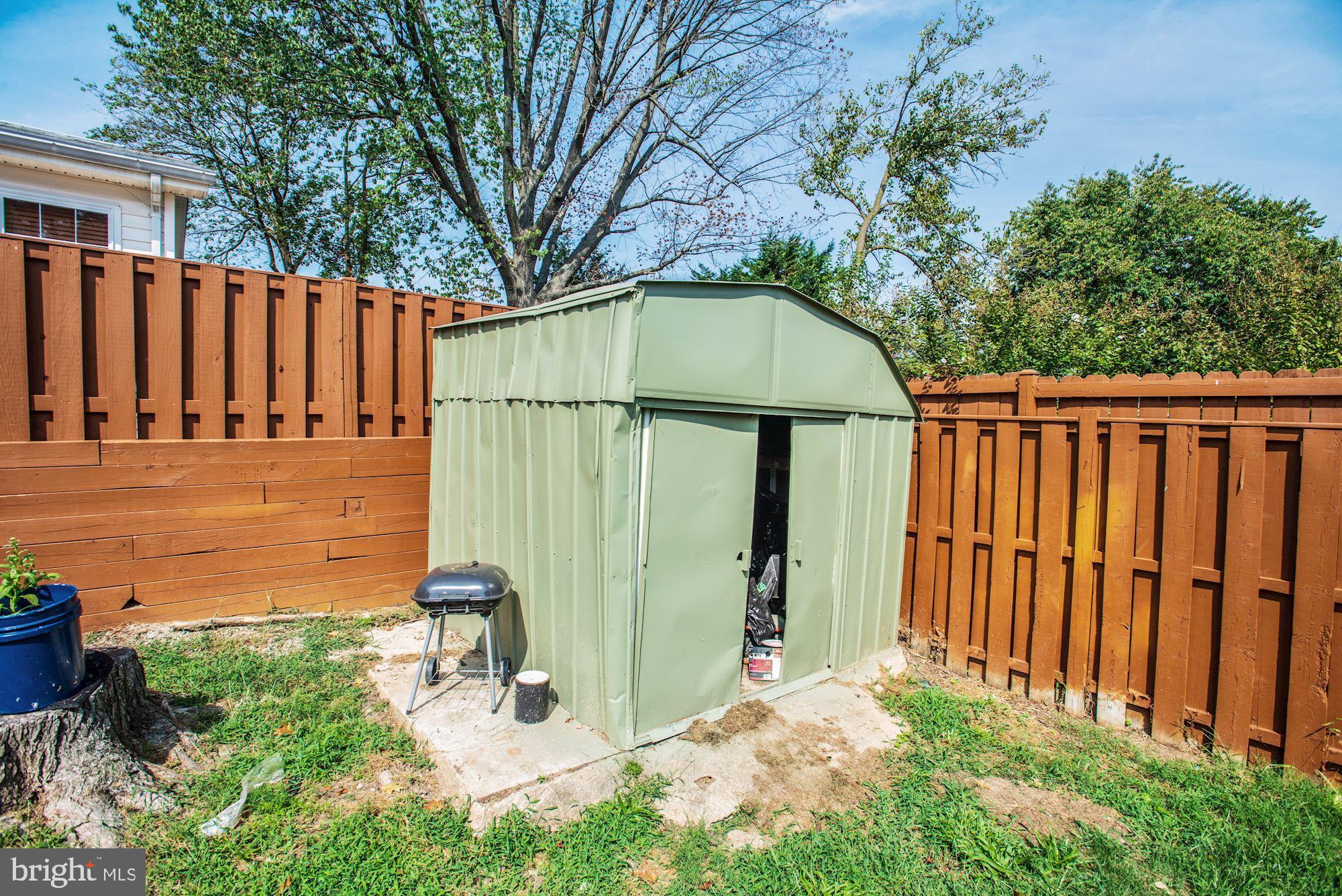 6708 Cimarron Street Springfield, VA 22150 - Photo 46 of 46 a backyard of a house with table and chairs