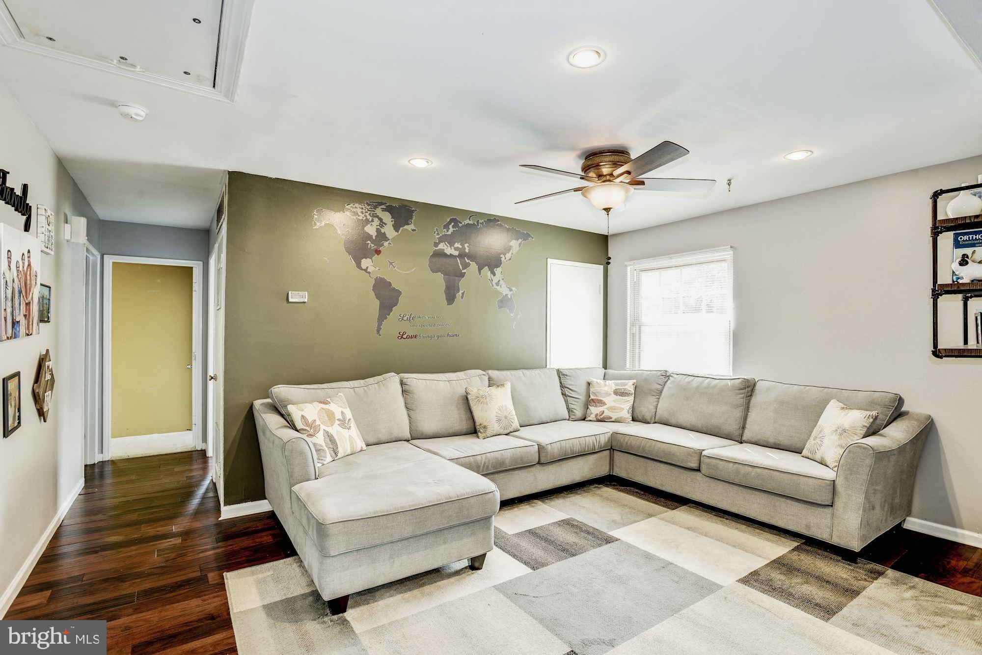 6708 Cimarron Street Springfield, VA 22150 - Photo 6 of 46 a living room with furniture and a ceiling fan