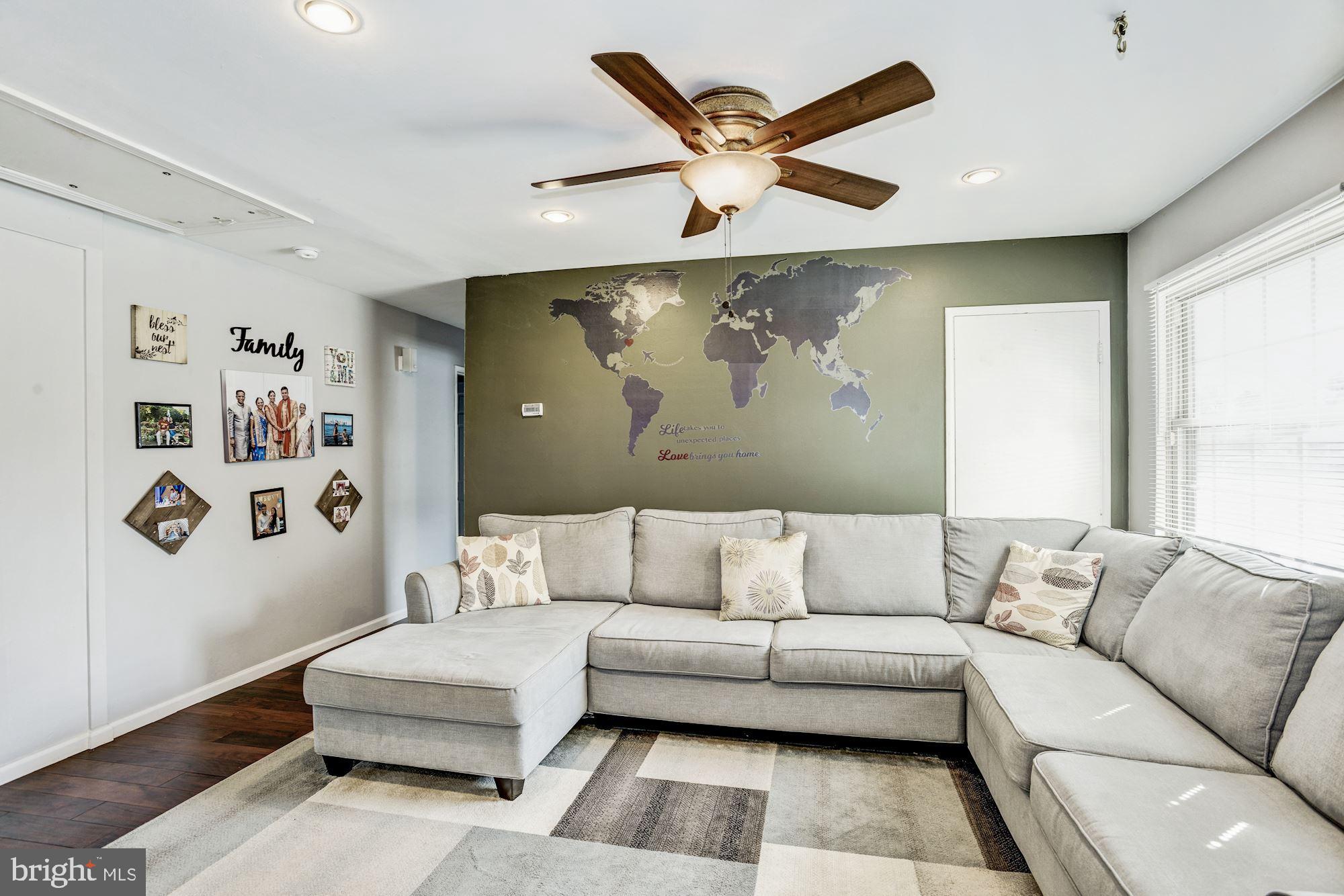 6708 Cimarron Street Springfield, VA 22150 - Photo 7 of 46 a living room with furniture and wall painting
