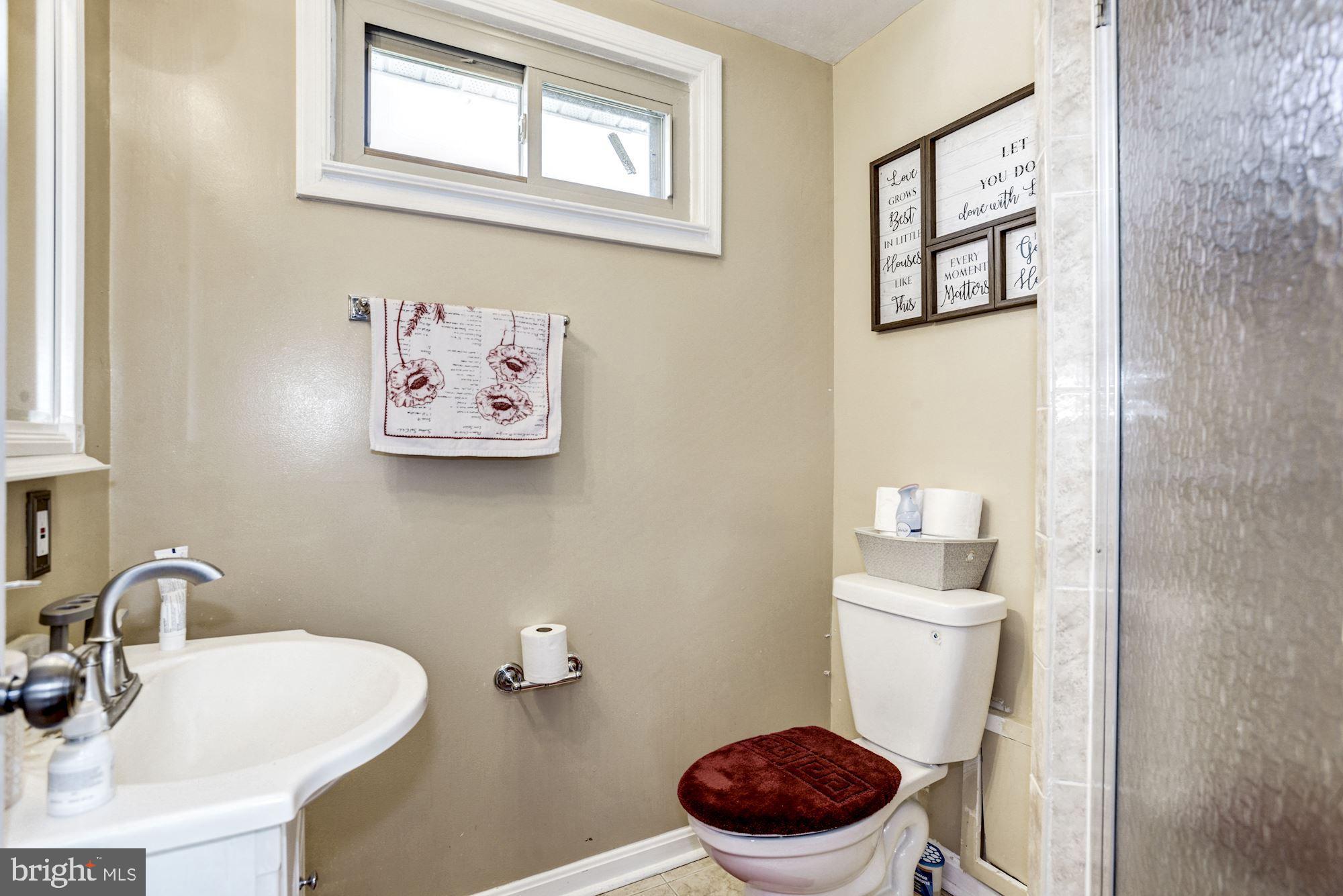 6708 Cimarron Street Springfield, VA 22150 - Photo 9 of 46 a bathroom with a toilet a sink and a mirror