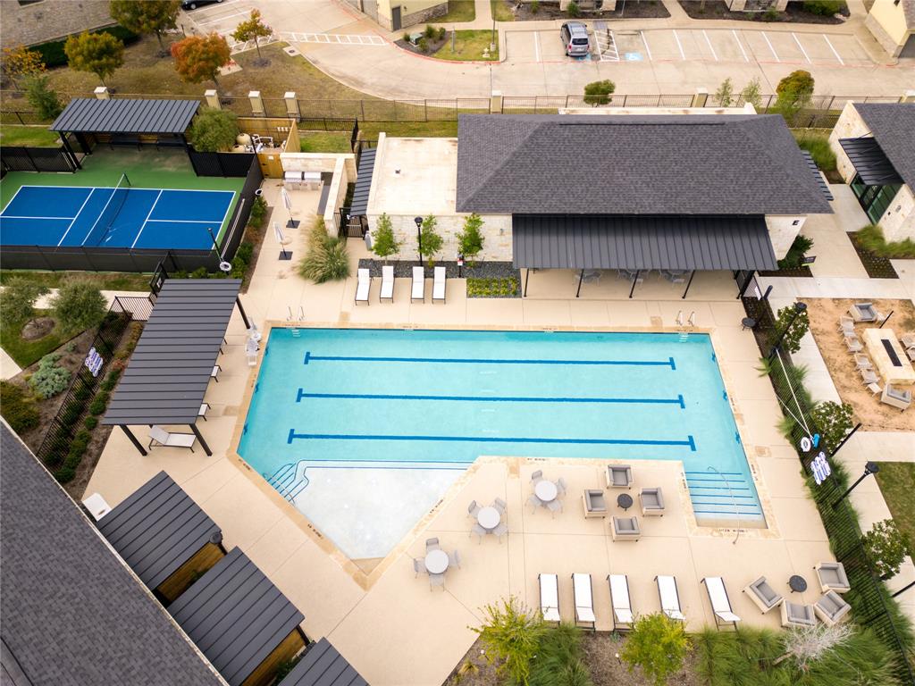 651 Watters Road, Unit 8204 Allen, TX 75013 - Photo 10 of 11 Resort-style pool with integrated steps, pickleball court, shaded lounge areas, and a fire pit feature
