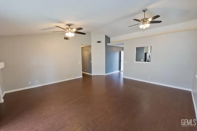a view of a big room with chandelier fan