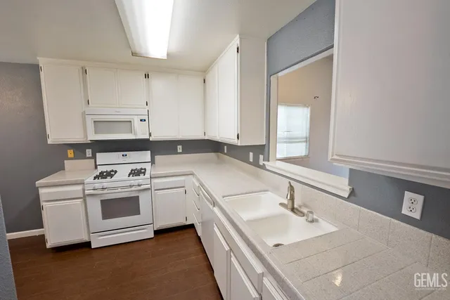 a kitchen with a sink stove and cabinets