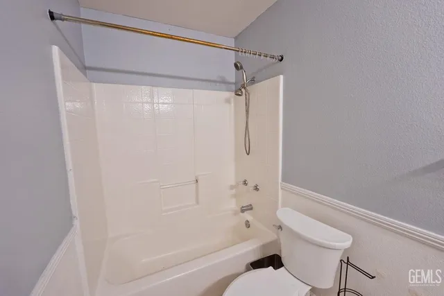 a bathroom with a shower and a toilet