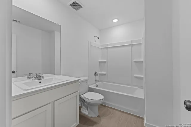 an empty room with a window and closet area