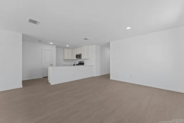 a kitchen with stainless steel appliances kitchen island sink refrigerator and cabinets