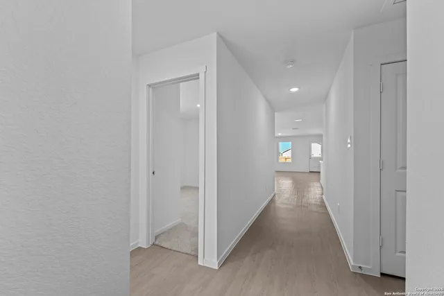 a view of a hallway with a room