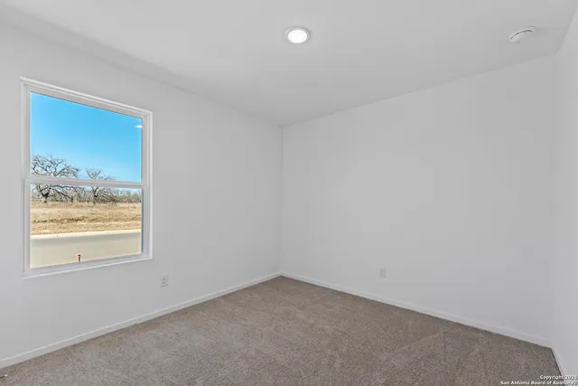 a view of an empty room and a window
