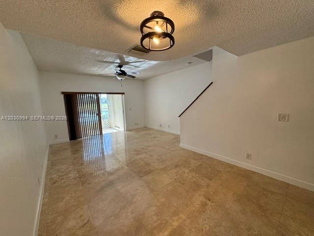 192 Southwest 96th Avenue, Unit 192 Plantation, FL 33324 - Photo 5 of 15 an empty room with chandelier fan and wooden floor