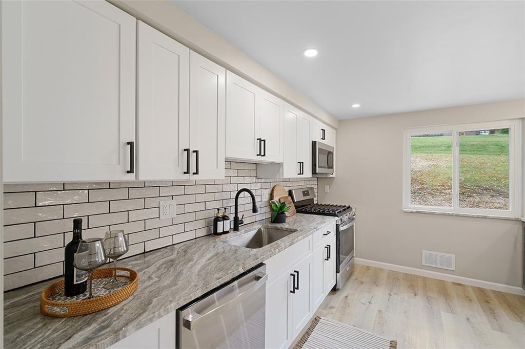 185 Grouse Drive Elizabeth, PA 15037 - Photo 14 of 45 a kitchen with granite countertop a sink and a stove