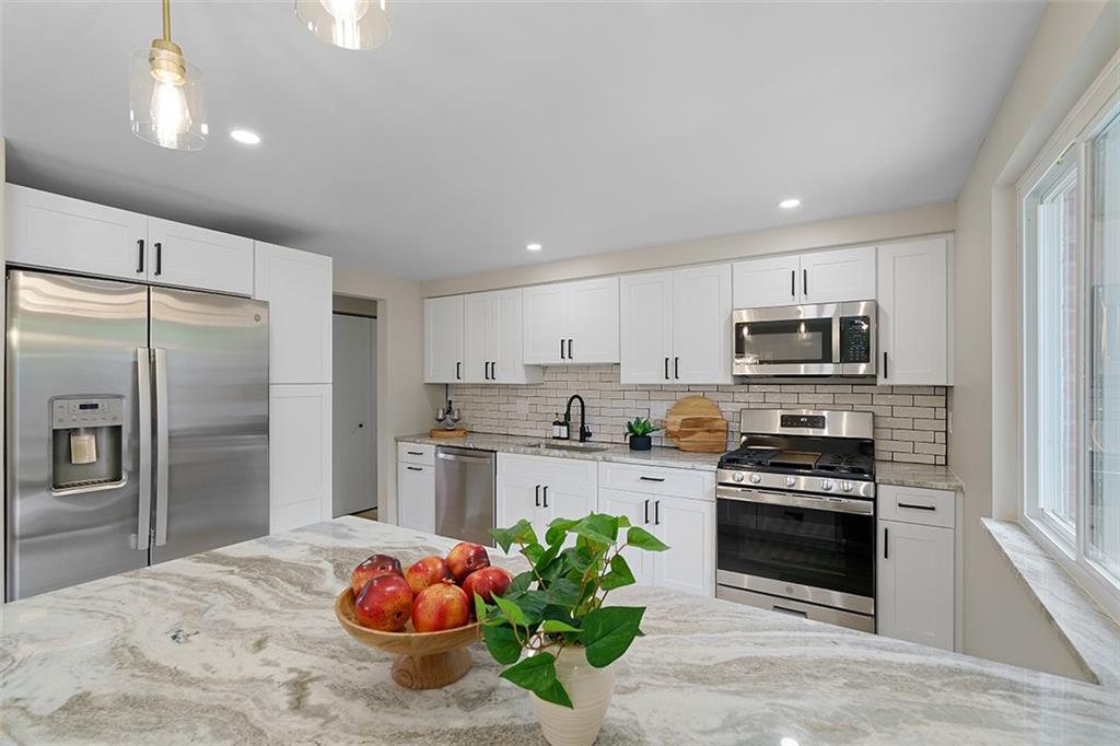 185 Grouse Drive Elizabeth, PA 15037 - Photo 16 of 45 a kitchen with stainless steel appliances kitchen island granite countertop a refrigerator stove and oven