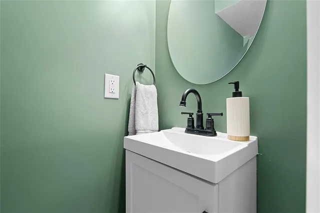 a view of a livingroom with chair and wooden floor