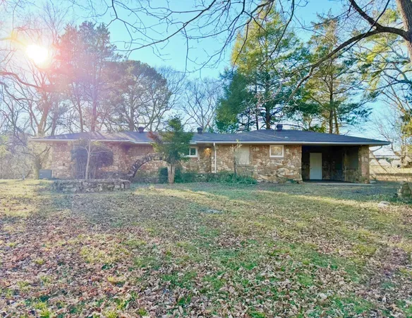 a view of a house with a yard and a tree