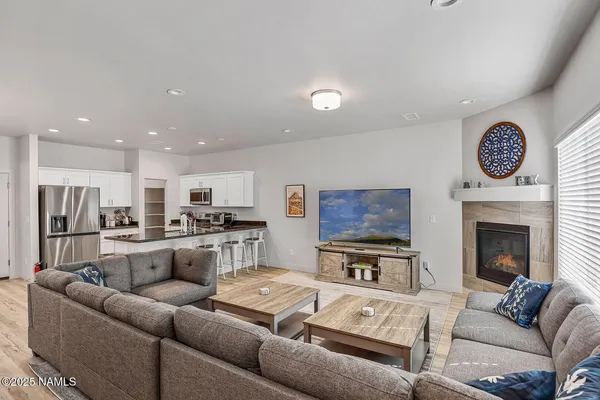 a living room with furniture and a fireplace