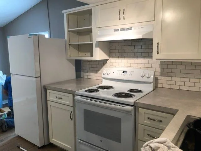 a kitchen with a stove and a refrigerator