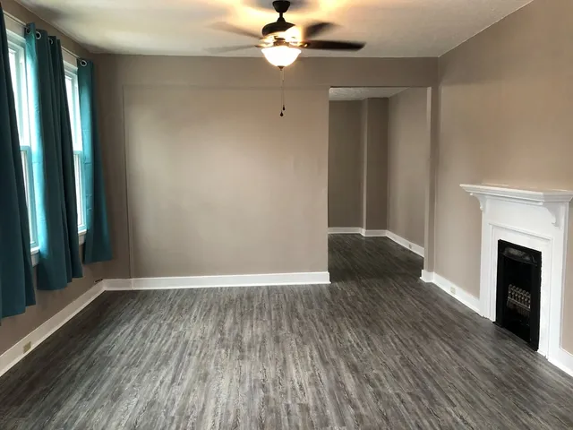 wooden floor in an empty room with a window