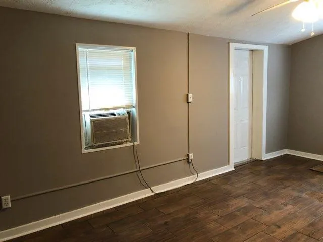 an empty room with windows and closet
