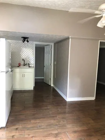 a kitchen with a refrigerator and a sink