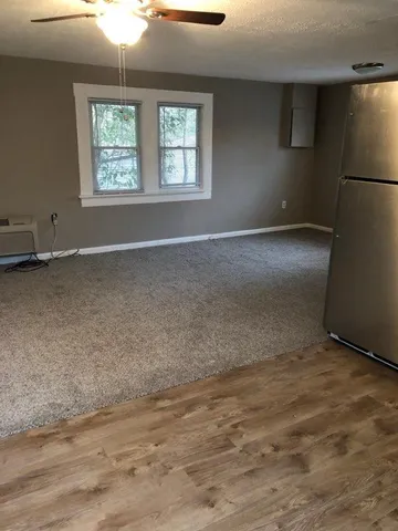 an empty room with a empty space and windows