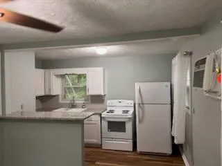 a kitchen with a white cabinets and white appliances