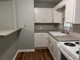 a kitchen with a sink stove and cabinets