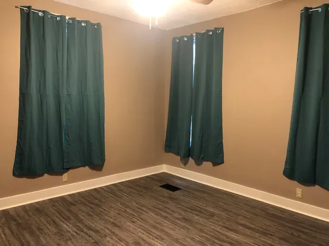 a view of a black door and wooden floor