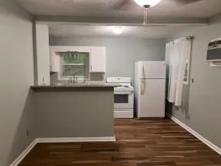 a room with refrigerator and window