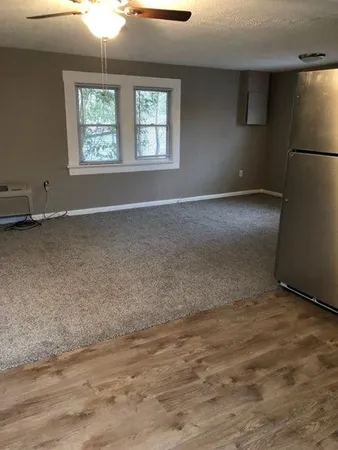 an empty room with a empty space and windows