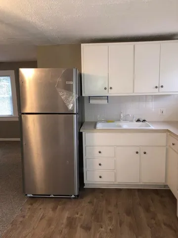 a white refrigerator freezer sitting in a kitchen