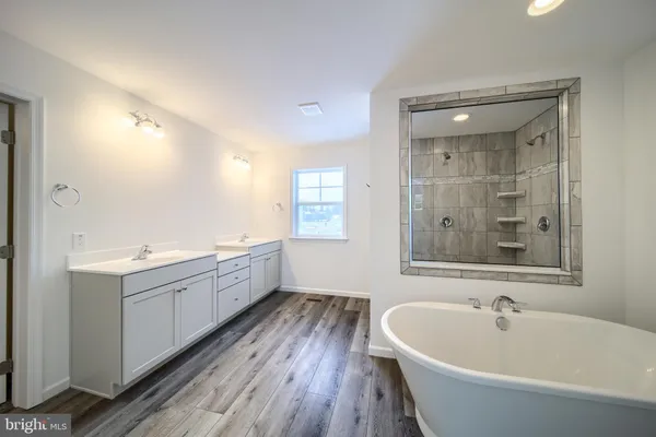 a bathroom with a bathtub and a sink