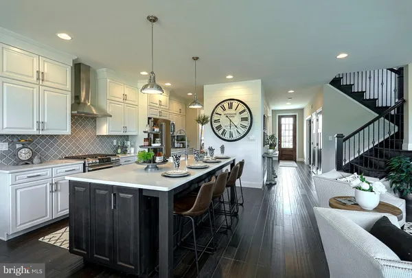 a view of a kitchen area with furniture and wooden floor