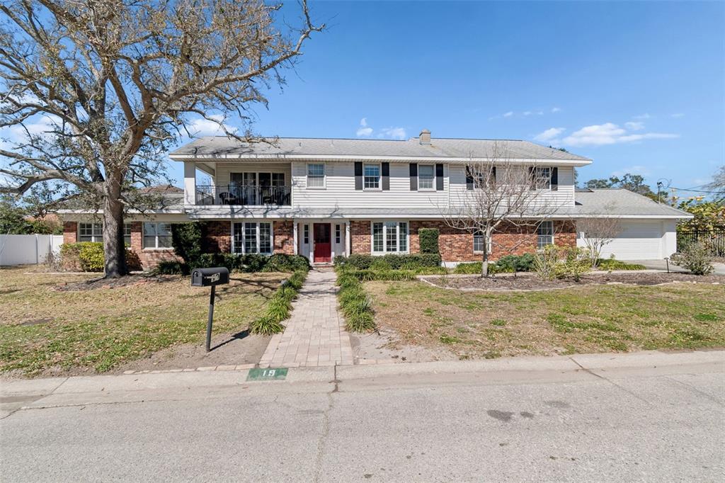 19 Sandpiper Road Tampa, FL 33609 - Photo 2 of 64 a front view of a house with a yard