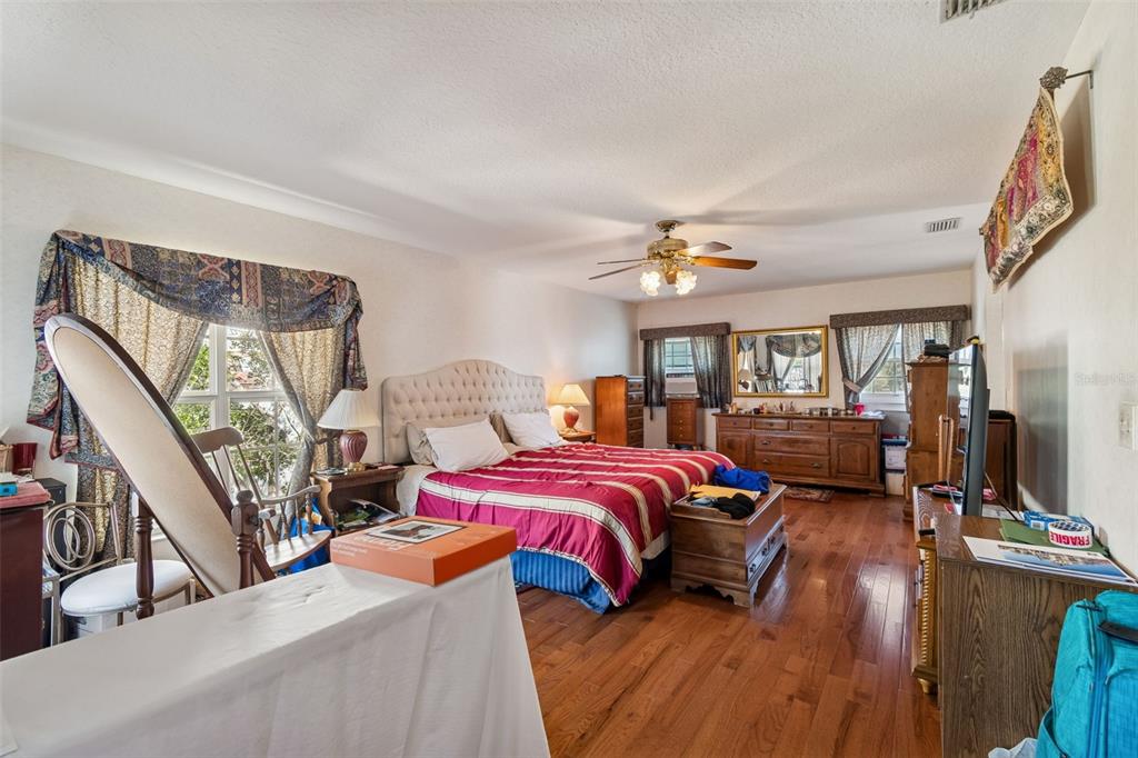 19 Sandpiper Road Tampa, FL 33609 - Photo 35 of 64 a bedroom with furniture and a wooden floor