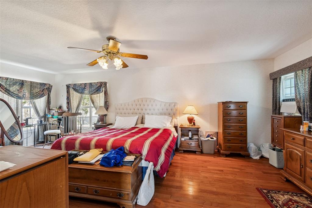 19 Sandpiper Road Tampa, FL 33609 - Photo 36 of 64 a bedroom with a bed and a chandelier