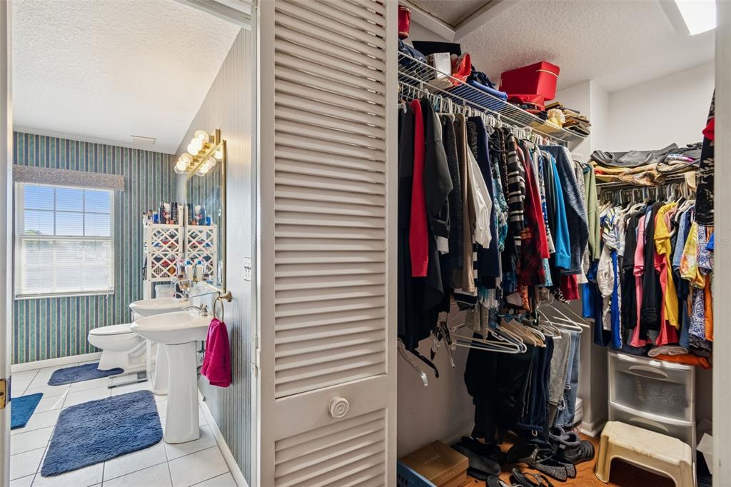 19 Sandpiper Road Tampa, FL 33609 - Photo 38 of 64 a view of walk in closet with clothes and shoes